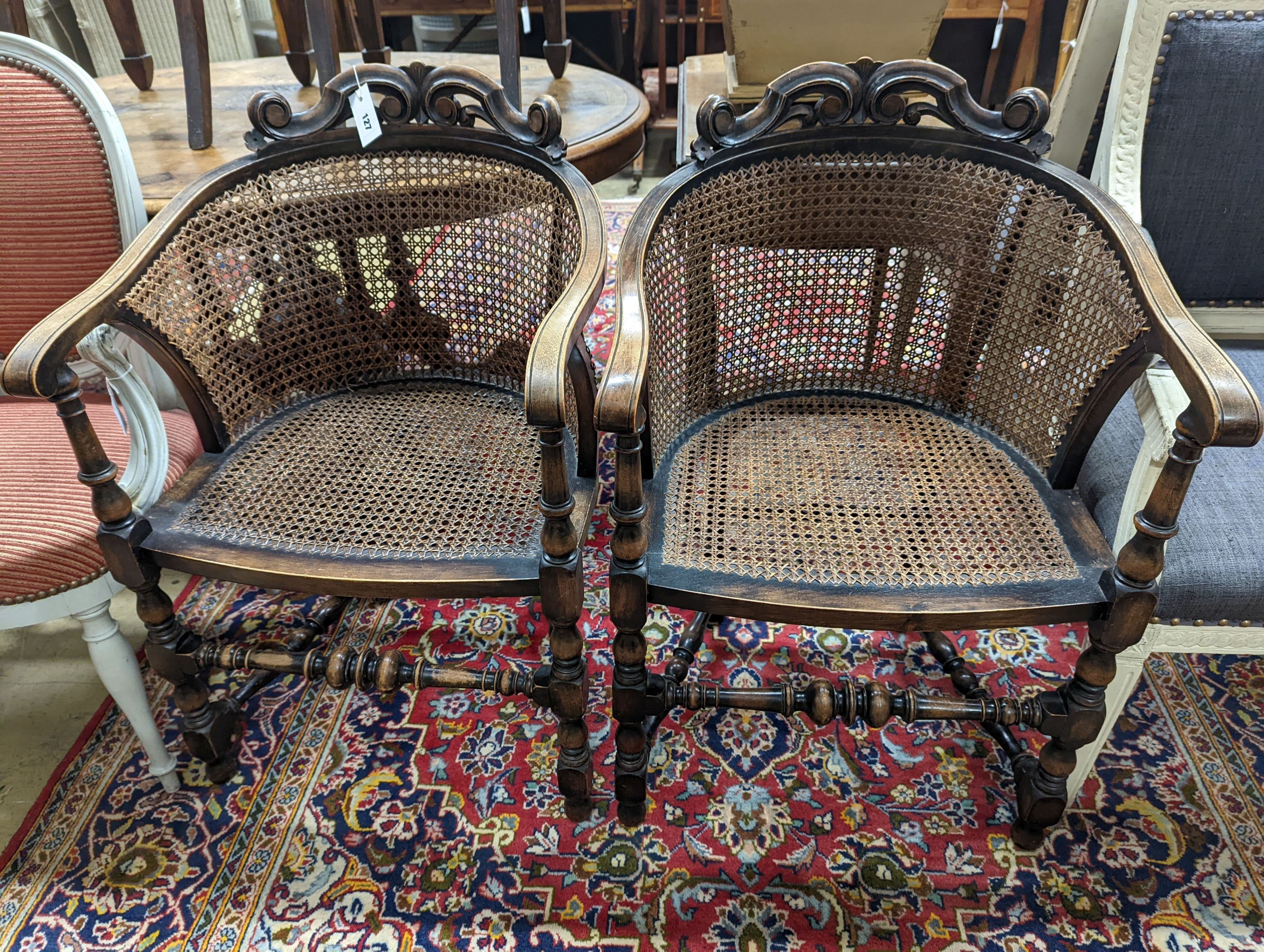 A pair of early 20th century Carolean style caned beech tub framed chairs, width 56cm, depth 48cm, height 85cm